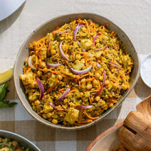 Load image into Gallery viewer, Vegetable salad with chickpeas and onions in a bowl on a checkered tablecloth.