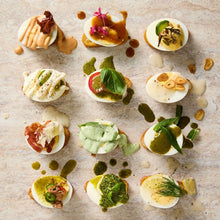 Load image into Gallery viewer, Eggs with different types of salad dressings on them placed on white marble