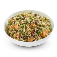 Load image into Gallery viewer, A bowl of herby quinoa and broccoli salad with green tahini dressing, including visible roasted sweet potato pieces, cranberries, and pepita seeds.