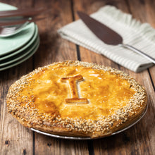 Load image into Gallery viewer, Chicken Leek Pie with a letter 'I' on top, placed on a wooden table with plates and a knife.