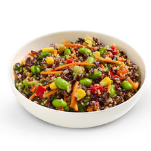 Load image into Gallery viewer, A bowl of Japanese Sesame Rice Salad with a mix of black rice, white quinoa, edamame, carrots, and other vegetables, dressed with a honey and apple cider dressing.