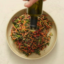 Load image into Gallery viewer, Kale and quinoa salad in a beige bowl with olive oil pouring over it