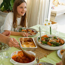Load image into Gallery viewer, Young girl eating a family dinner at a table