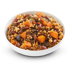 Load image into Gallery viewer, A bowl of spiced Israeli couscous salad with ingredients including pearl couscous, lentils, chickpeas, sweet potato, sultanas, and almonds, dressed in a mint sauce.