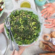 Load image into Gallery viewer, Green Goddess Salad in bowl Passing between two sets of hands over a table