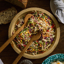 Load image into Gallery viewer, Corn & Coriander Slaw in a wooden bowl with wooden salad severs
