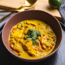 Load image into Gallery viewer, Loaded veggie Indian curry in a brown bowl garnished with fresh coriander