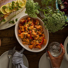 Load image into Gallery viewer, Sweet Potato & Pine Nut salad in a white oval bowl on a table
