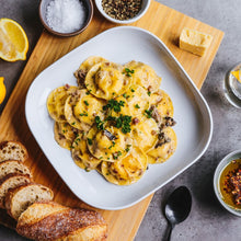 Load image into Gallery viewer, Ravioli with parsley garnish on a square white plate