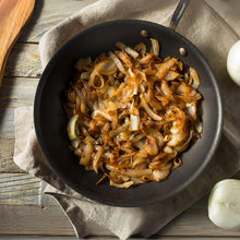 Load image into Gallery viewer, Caramelised sliced onions in a frying pan