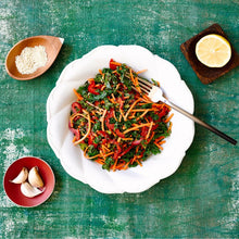 Load image into Gallery viewer, Kale & Quinoa with Tahini salad served on a round white plate with a fork