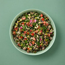 Load image into Gallery viewer, A green bowl of Quinoa Tabbouleh on a green background