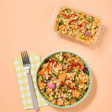 Load image into Gallery viewer, Roasted Vegetable Cous Cous in a green bowl and plastic container on a peach coloured background