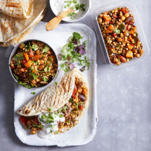 Load image into Gallery viewer, Flatbread stuffed with Spiced Israeli Couscous and mint yoghurt dressing folded in half