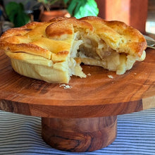 Load image into Gallery viewer, Apple pie on a wooden stand with a blurred background
