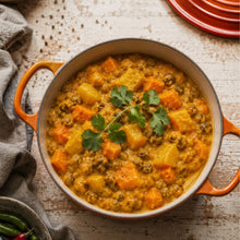 Load image into Gallery viewer, Hearty vegetable curry with sweet potato and chickpeas, garnished with fresh coriander.