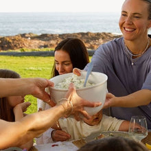 Load image into Gallery viewer, People enjoying a meal outdoors with a scenic background
