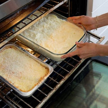 Load image into Gallery viewer, Person removing two baking dishes from an oven
