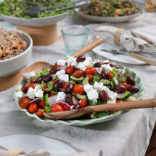 Load image into Gallery viewer, Colorful salad with tomatoes, cucumbers, and feta cheese in a bowl on a table.
