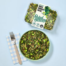 Load image into Gallery viewer, Green goddess salad in a bowl with a container labeled &#39;Salad Servers&#39; on a light blue background.
