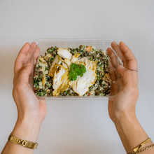 Load image into Gallery viewer, Person holding a lentil tabbouleh with Middle Eastern chicken protein salad.
