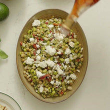 Load image into Gallery viewer, Salad with green beans, white cheese, and red peppers in a brown bowl on a light surface.
