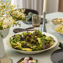 Load image into Gallery viewer, Salad on a table with flowers and candles in the background

