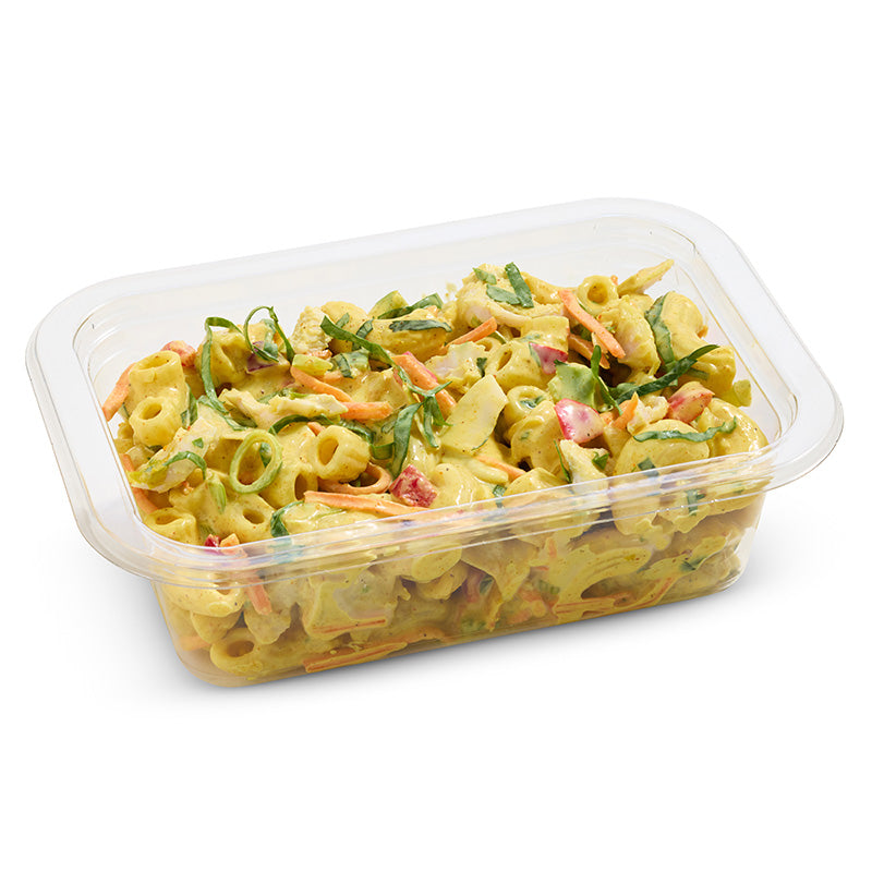 Pasta salad in a clear plastic container on a white background