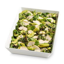 Load image into Gallery viewer, Green Goddess Chicken Leafy Kit consisting of mesclun lettuce, creamy avocado, tender poached chicken, and a green goddess salad with a tahini dressing, served in a white rectangular bowl.
