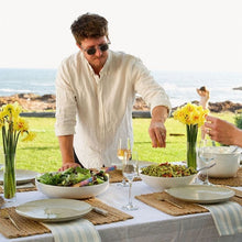 Load image into Gallery viewer, Man serving Mesclun Mix leaf in white bowl on table
