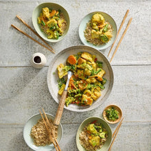 Load image into Gallery viewer, Plated dish of vegetable stir-fry with rice on a textured surface
