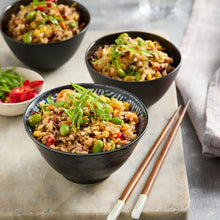 Load image into Gallery viewer, Three bowls of fried rice with vegetables on a marble surface with chopsticks.
