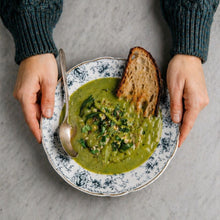 Load image into Gallery viewer, Green broccoli soup in a bowl on grey background with bread delivered to your door
