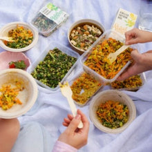 Load image into Gallery viewer, Picnic on white blanket with lots of salads
